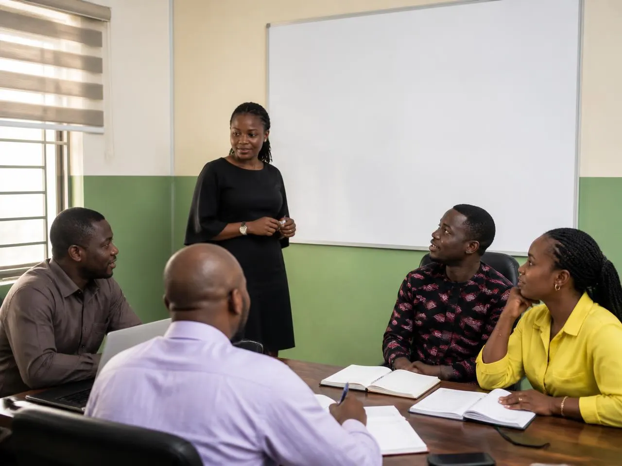 A facilitator leading a practical workshop session with a small professional team
